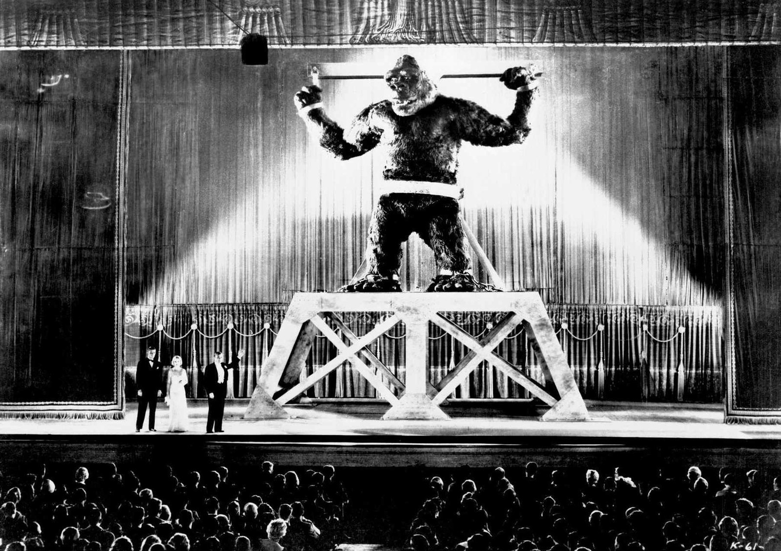 Kong, chained on a stage platform under spotlights before a packed theater audience, in King Kong (1933)